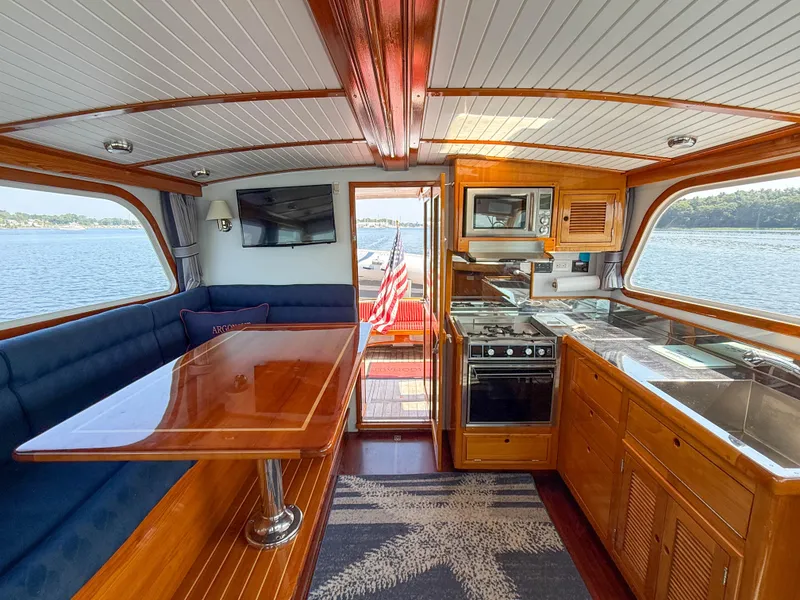 Slide: The Image of Interior of 1984 Wilbur 38 boat with kitchen, dining area, and scenic water view. - 32