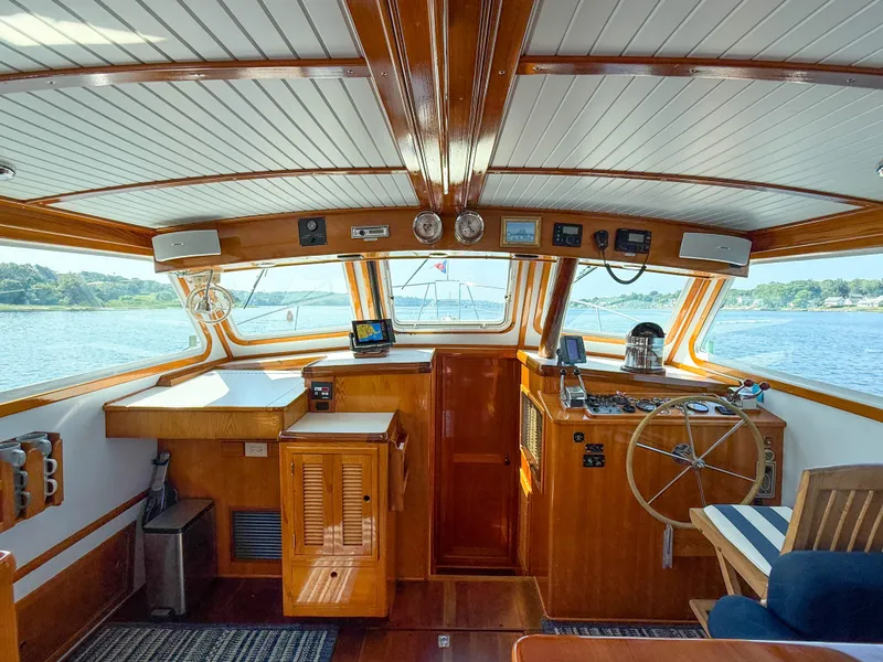 Slide: The Image of Interior of a 1984 Wilbur 38 boat with wooden finishes and navigational equipment. - 34