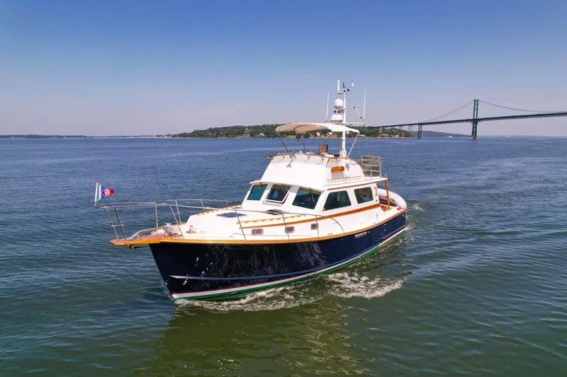 Slide: The Image of 1984 Wilbur 38 yacht cruising near a bridge on a sunny day. - 4