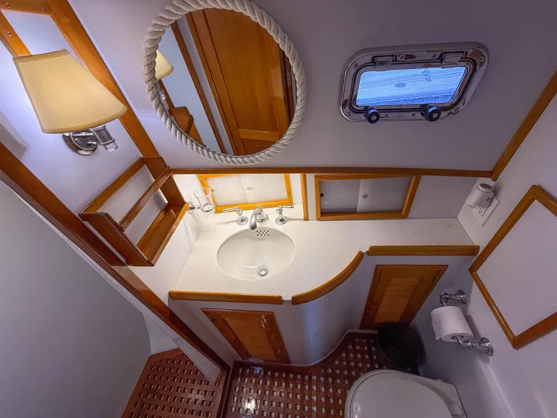 Slide: The Image of Luxurious 1984 Wilbur 38 yacht bathroom with wooden accents and nautical decor. - 41