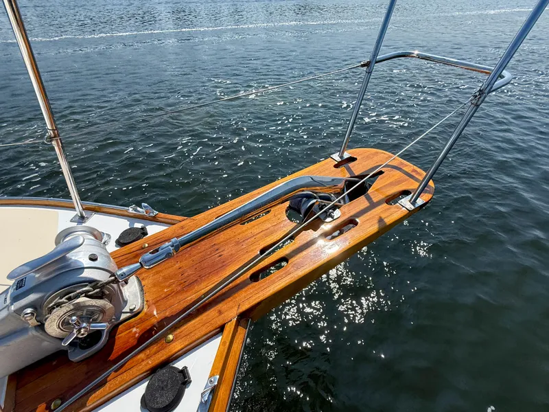 Slide: The Image of Bow of 1984 Wilbur 38 boat with anchor and wooden deck over water. - 48