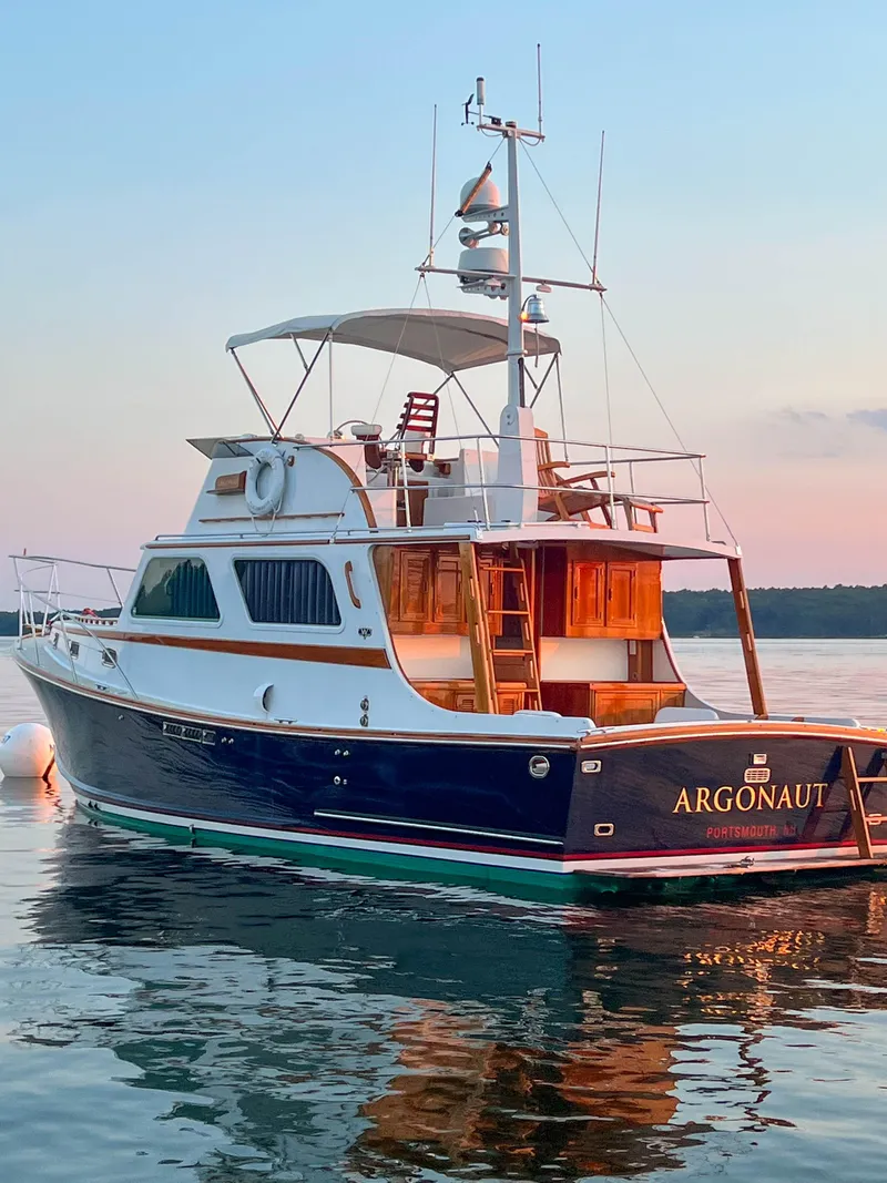 Slide: The Image of 1984 Wilbur 38 yacht "Argonaut" on calm water at sunset. - 6