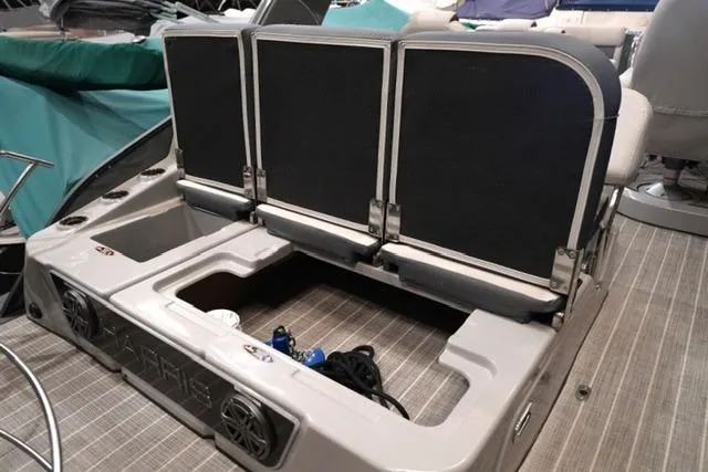 Slide: The Image of 2023 Harris Grand Mariner 250 SLDH boat interior with storage compartment and seating. - 11