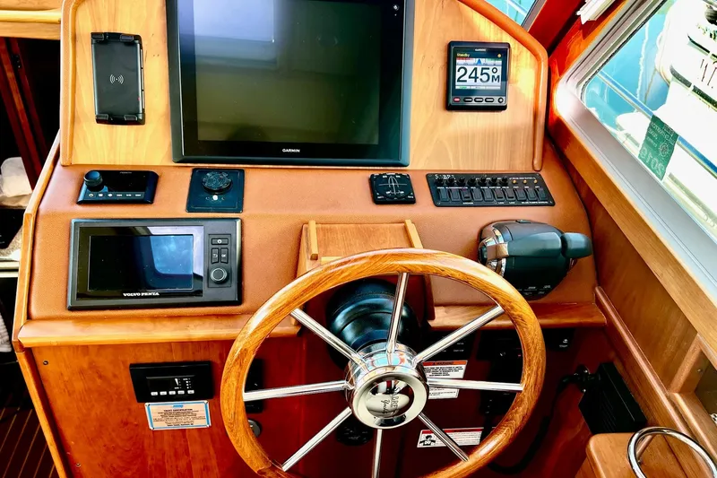 Slide: The Image of 2016 Sabre 38 Salon Express helm with Garmin display and wooden steering wheel. - 10