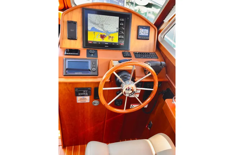 Slide: The Image of Helm of 2016 Sabre 38 Salon Express with navigation equipment and wooden steering wheel. - 11