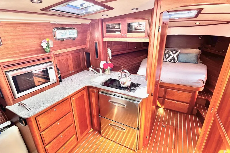 Slide: The Image of Interior of 2016 Sabre 38 Salon Express yacht with modern kitchen and cozy bedroom. - 13