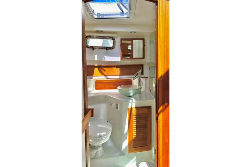 Slide: The Image of Interior of 2016 Sabre 38 Salon Express yacht bathroom with skylight and wooden accents. - 20