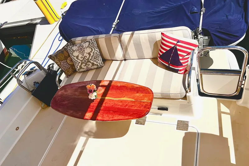 Slide: The Image of Cozy seating area on 2016 Sabre 38 Salon Express yacht with decorative pillows and wooden table. - 25