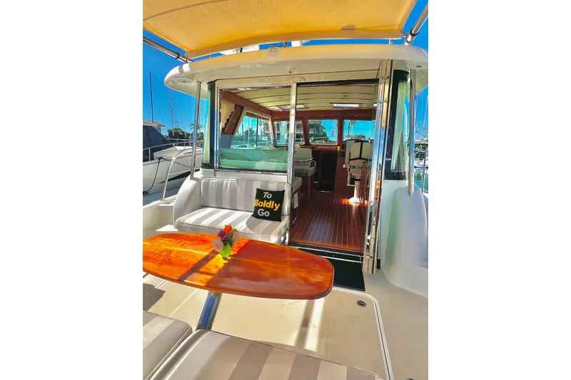 Slide: The Image of 2016 Sabre 38 Salon Express yacht interior with seating, table, and "To Boldly Go" pillow. - 27