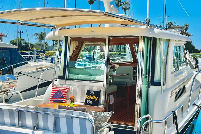 Slide: The Image of 2016 Sabre 38 Salon Express yacht docked, featuring a stylish outdoor seating area. - 30