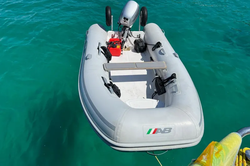 Slide: The Image of Inflatable boat with motor floating on clear turquoise water. - 31