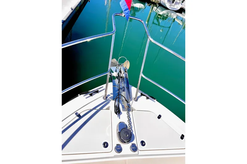 Slide: The Image of Bow view of 2016 Sabre 38 Salon Express with anchor and railing in marina. - 33