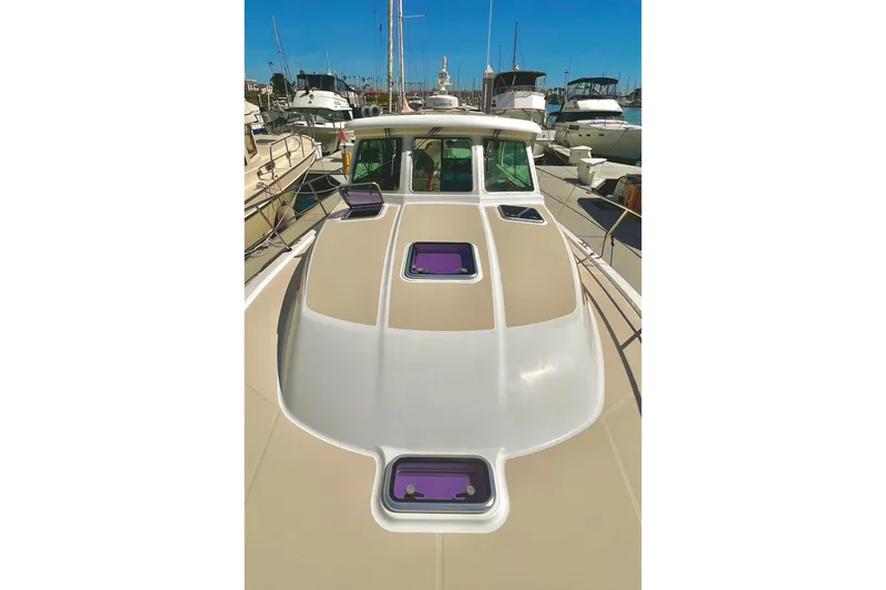 Slide: The Image of 2016 Sabre 38 Salon Express yacht docked in a marina, showcasing sleek design and hatches. - 34