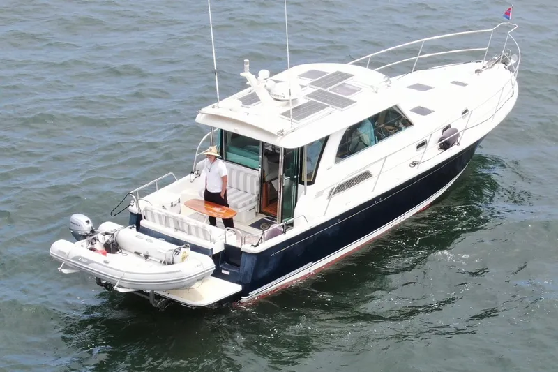 Slide: The Image of 2016 Sabre 38 Salon Express yacht on water with a person on deck. - 37