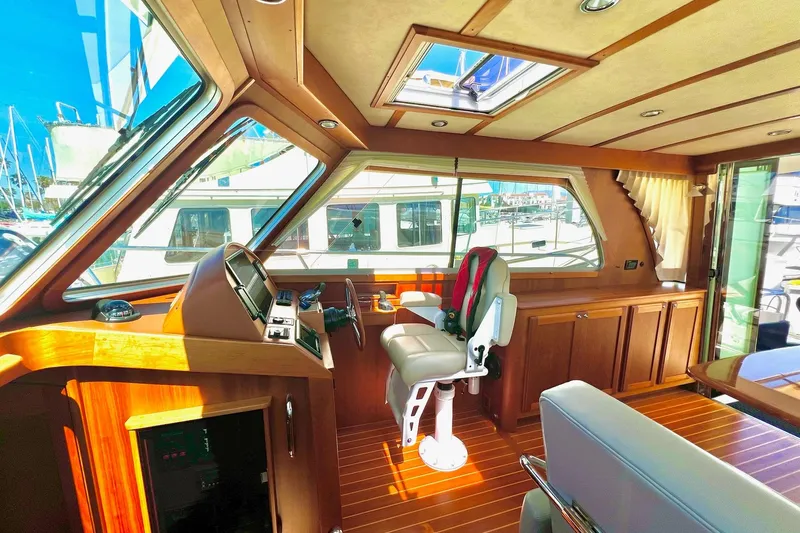 Slide: The Image of Interior of 2016 Sabre 38 Salon Express yacht with wooden finishes and helm station. - 9