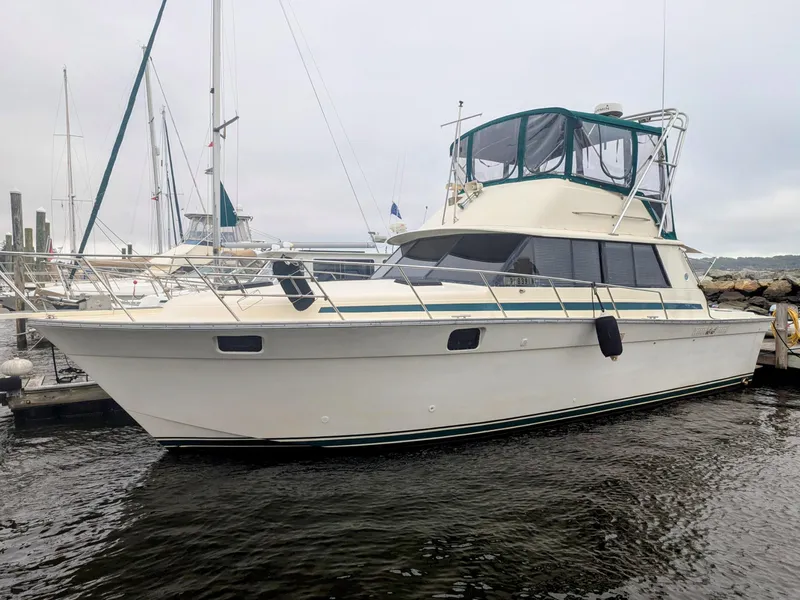 The Image of 1981 Silverton 37 Convertible yacht docked at marina, featuring classic design and spacious deck. - 0