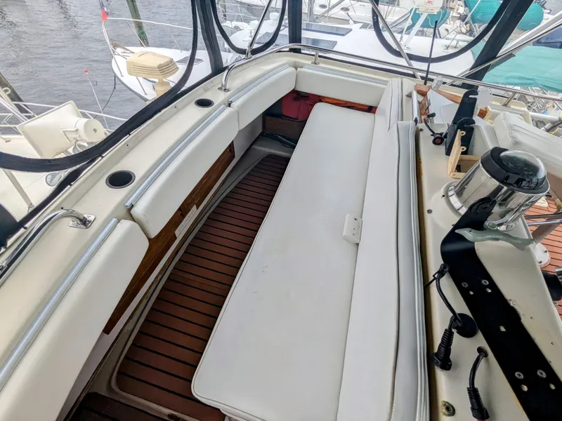 Slide: The Image of 1981 Silverton 37 Convertible boat interior with white seating and wooden flooring. - 12