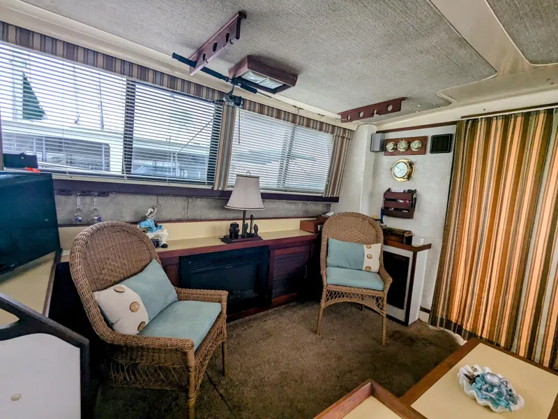 Slide: The Image of Interior of a 1981 Silverton 37 Convertible yacht with wicker chairs and nautical decor. - 19