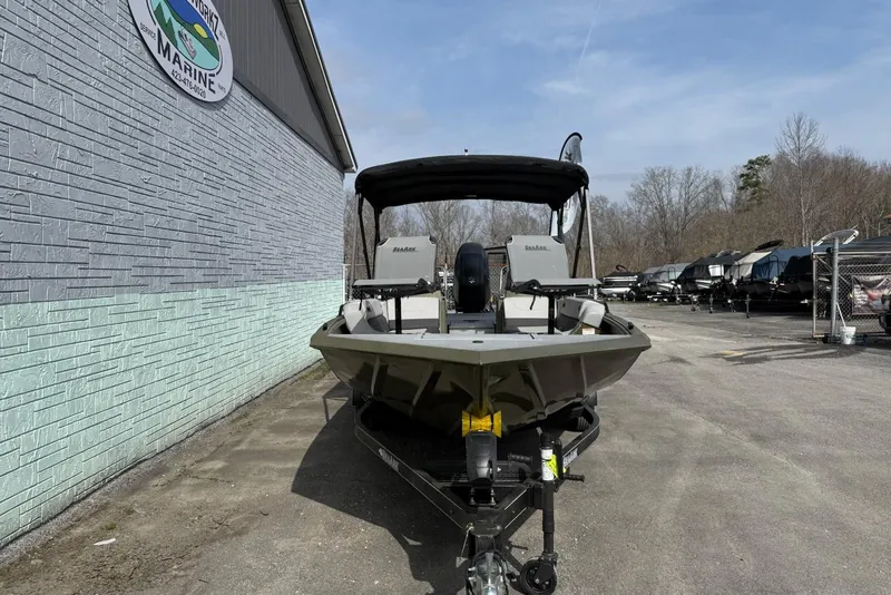 Slide: The Image of 2026 SeaArk Easy 200 boat on trailer, parked outside a marine dealership. - 4
