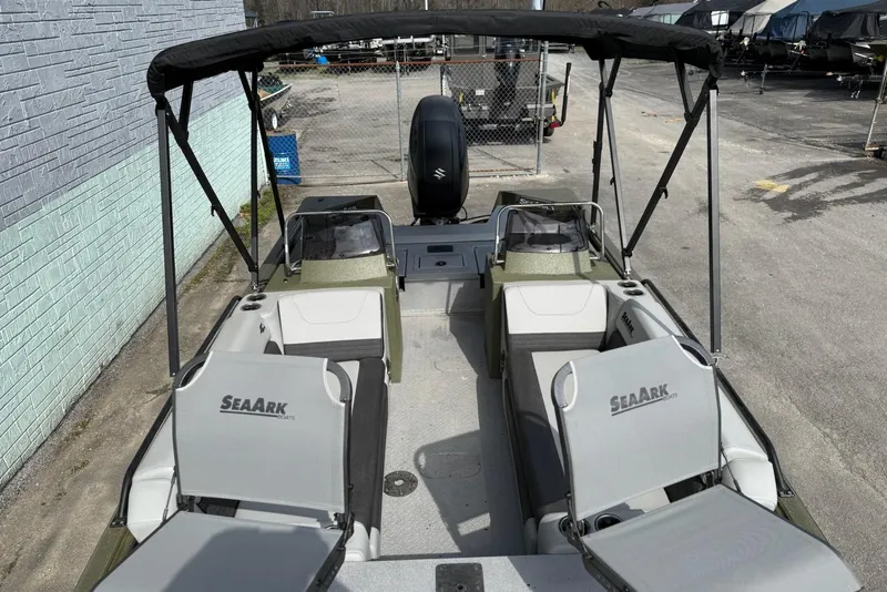 Slide: The Image of 2026 SeaArk Easy 200 boat with seating and canopy, parked outdoors. - 7