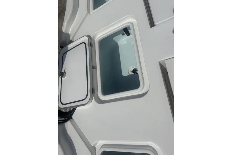 Slide: The Image of 2017 Sportsman Masters 267 Bay Boat storage compartments with open hatches. - 15