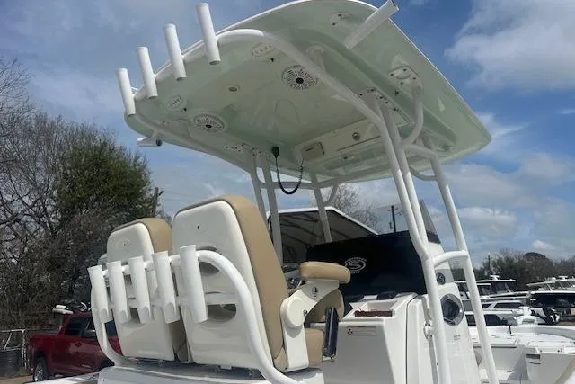 Slide: The Image of 2017 Sportsman Masters 267 Bay Boat with T-top and rod holders under a blue sky. - 23