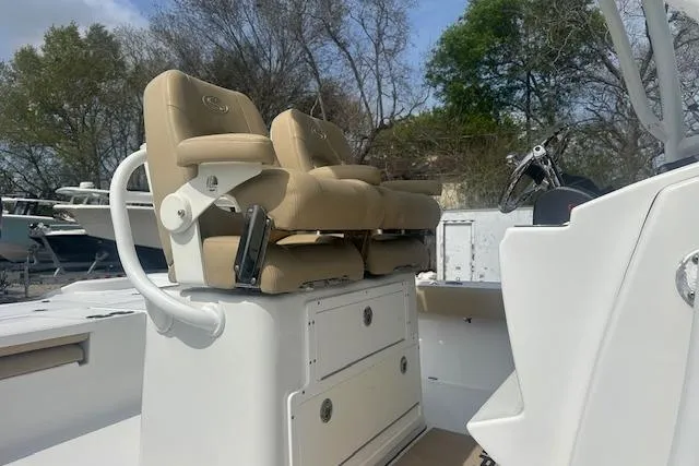 Slide: The Image of 2017 Sportsman Masters 267 Bay Boat with tan seating and console, outdoors. - 24