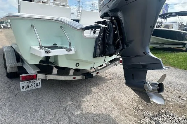 Slide: The Image of 2017 Sportsman Masters 267 Bay Boat on trailer, rear view with outboard motor. - 4