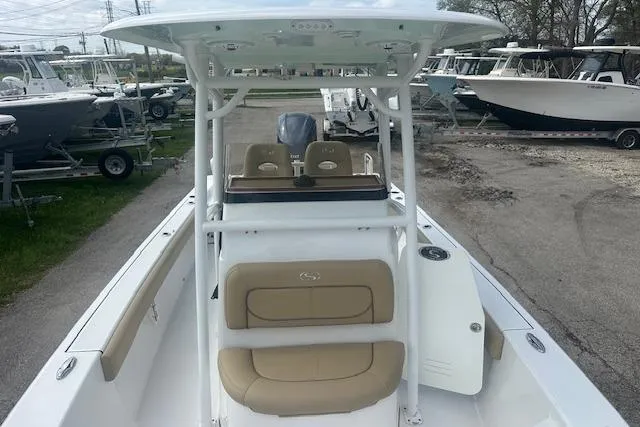 Slide: The Image of 2017 Sportsman Masters 267 Bay Boat with T-top and seating, parked in a marina. - 9