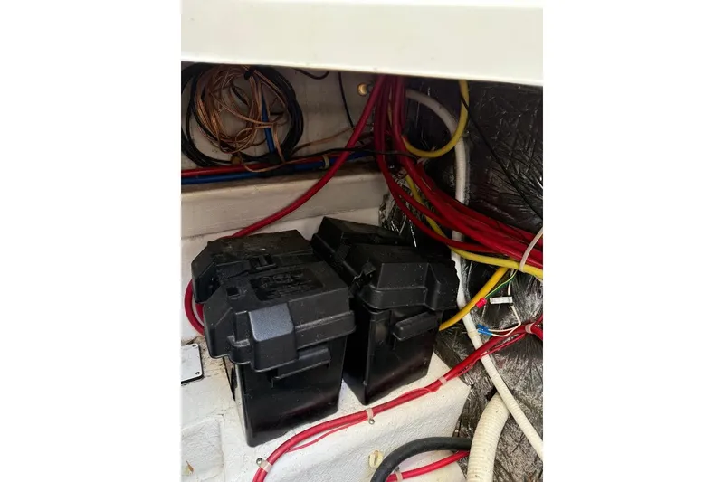 Slide: The Image of Electrical wiring and battery compartment in a 2005 Bayliner 305 boat. - 8