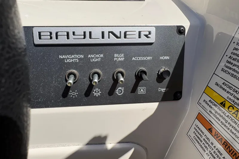 Slide: The Image of Control panel of a 2016 Bayliner 160 Bowrider boat with labeled switches. - 10
