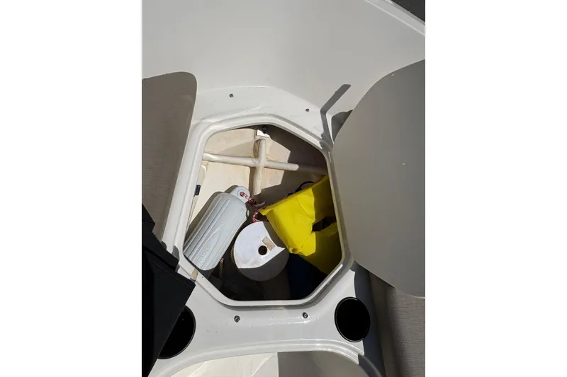 Slide: The Image of Storage compartment of a 2016 Bayliner 160 Bowrider with boating accessories. - 11