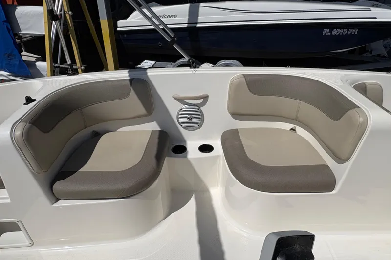 Slide: The Image of 2016 Bayliner 160 Bowrider interior with beige seating and cup holders. - 7