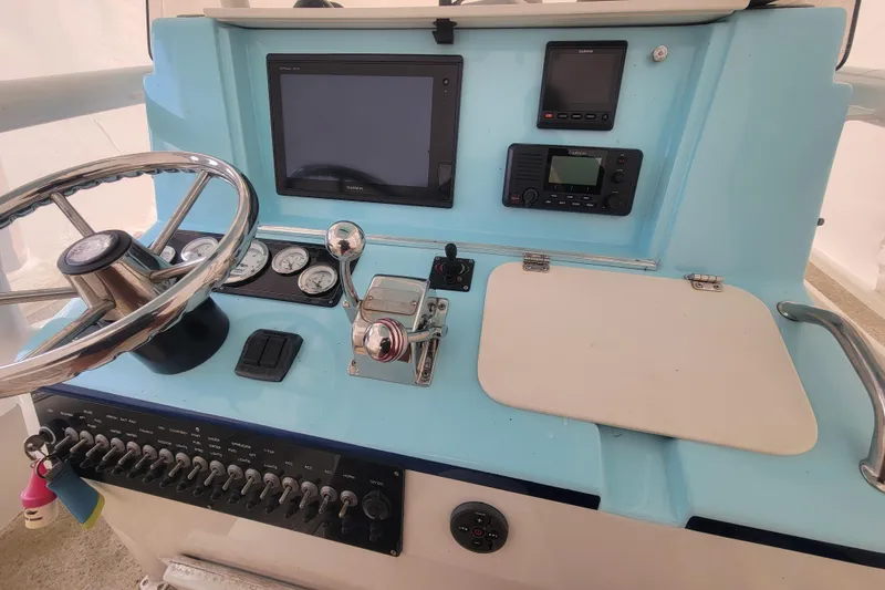 Slide: The Image of Center console of 2001 Shamrock 22 Open boat with steering wheel and navigation instruments. - 10