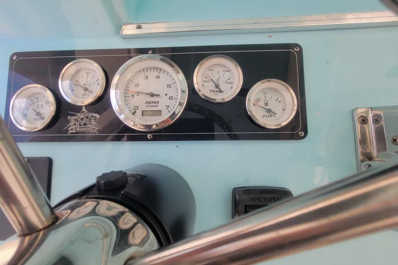 Slide: The Image of Dashboard of a 2001 Shamrock 22 Open boat with gauges and controls. - 13