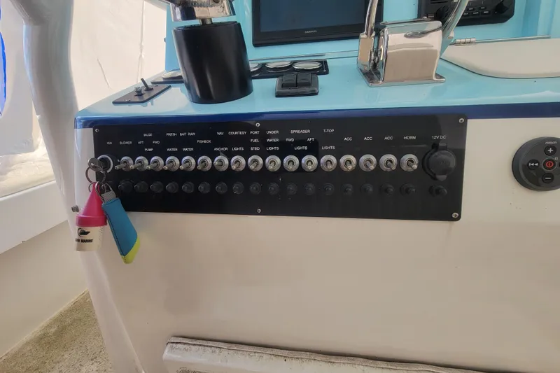 Slide: The Image of Control panel of a 2001 Shamrock 22 Open Center Console boat with labeled switches. - 14