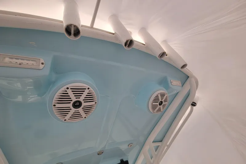 Slide: The Image of 2001 Shamrock 22 Open center console boat interior with speakers and rod holders. - 17