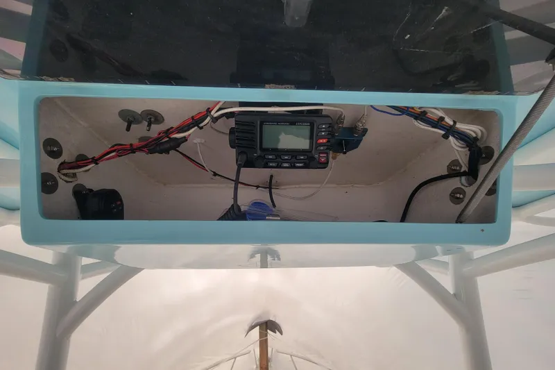 Slide: The Image of 2001 Shamrock 22 Open Center Console electronics compartment with wiring and radio equipment. - 18