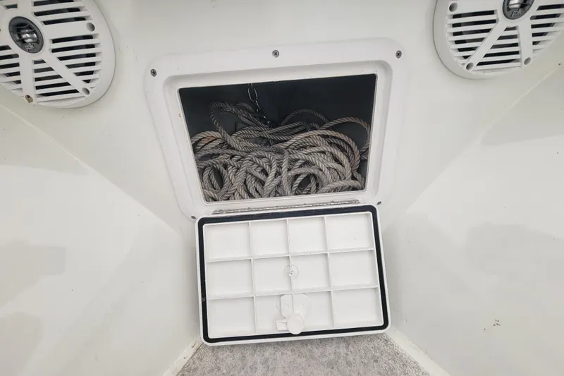 Slide: The Image of Storage compartment with rope on a 2001 Shamrock 22 Open Center Console boat. - 21