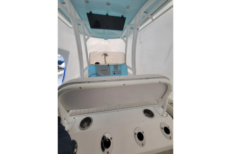Slide: The Image of 2001 Shamrock 22 Open Center Console boat interior with blue accents and fishing rod holders. - 27