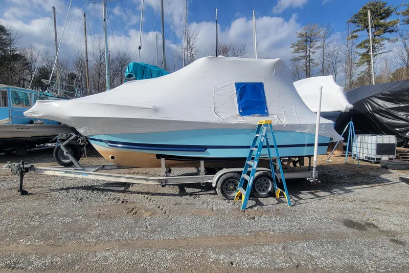 Slide: The Image of 2001 Shamrock 22 Open Center Console boat covered, on trailer, with ladder nearby. - 28