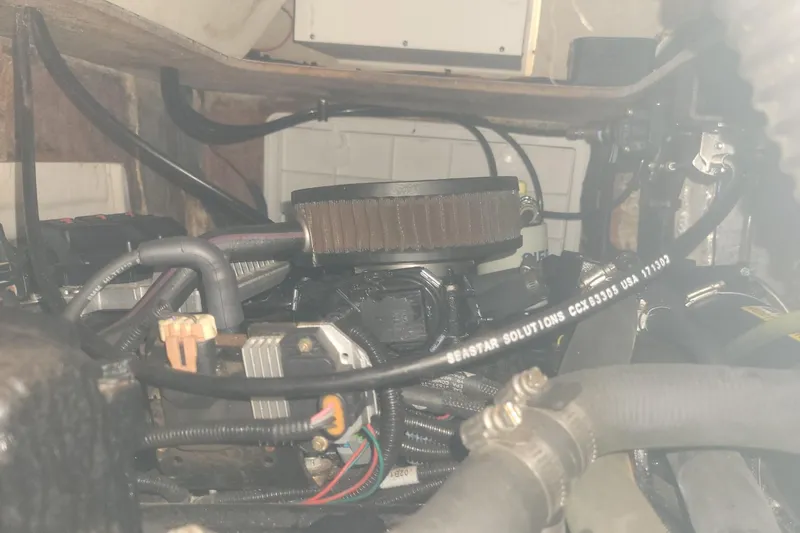 Slide: The Image of Engine compartment of a 2001 Shamrock 220 Open boat, showing hoses and components. - 37