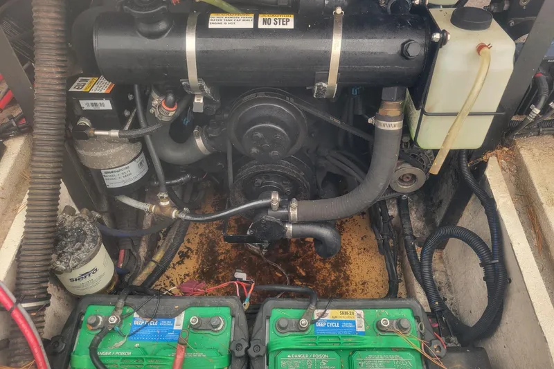 Slide: The Image of Engine compartment of a 2001 Shamrock 220 Open boat with visible batteries and components. - 38