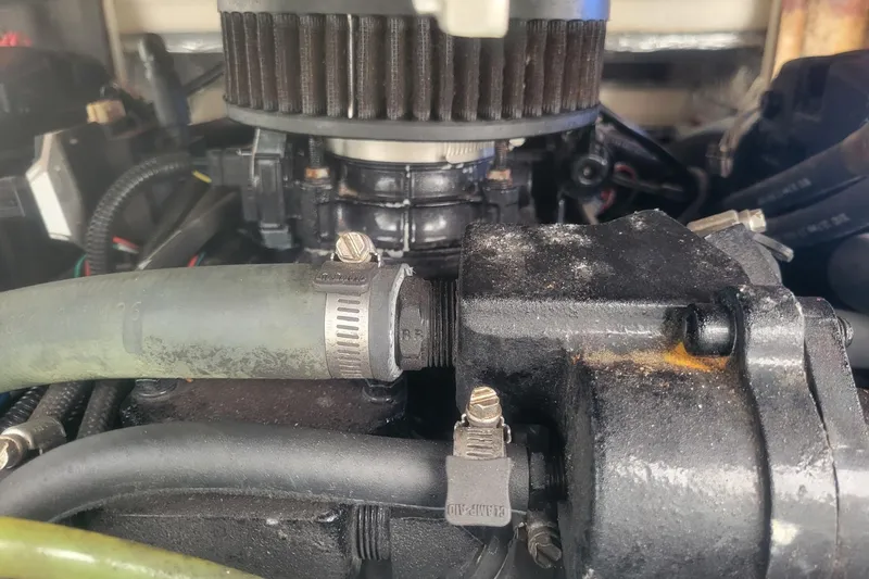 Slide: The Image of Close-up of a 2001 Shamrock 220 Open engine with visible hoses and clamps. - 40