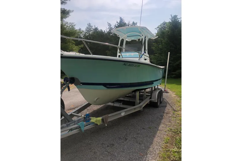 Slide: The Image of 2001 Shamrock 22 Open Center Console boat on trailer, parked outdoors. - 4