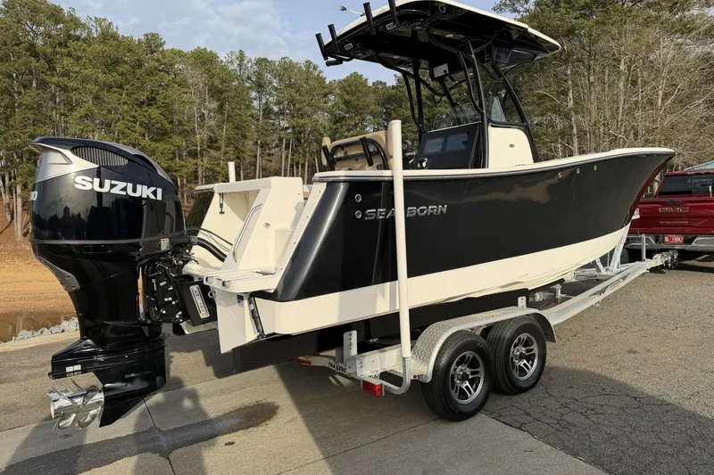 The Image of 2024 Sea Born SX239 Offshore boat on trailer with Suzuki outboard motor. - 1