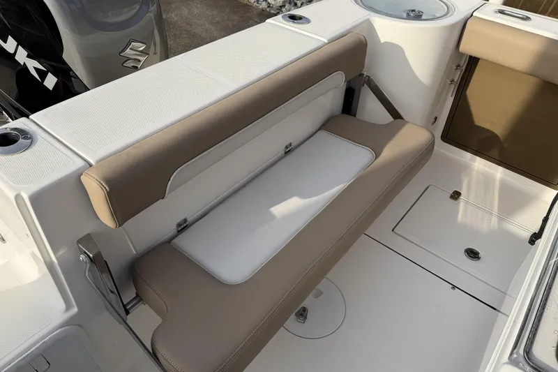 Slide: The Image of 2024 Sea Born SX239 Offshore boat interior with cushioned seating and storage. - 14