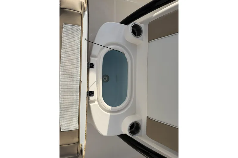 Slide: The Image of 2024 Sea Born SX239 Offshore boat interior with storage compartment and seating. - 28