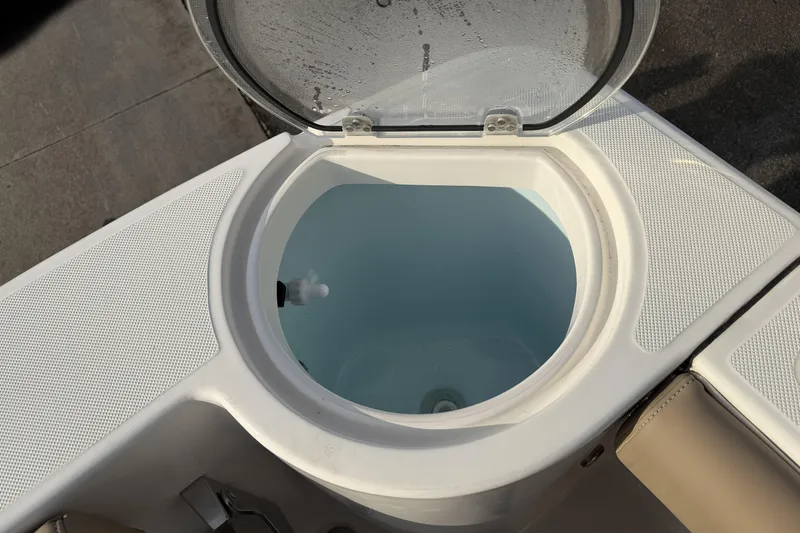 Slide: The Image of 2024 Sea Born SX239 Offshore boat livewell with open lid, showcasing interior design. - 29