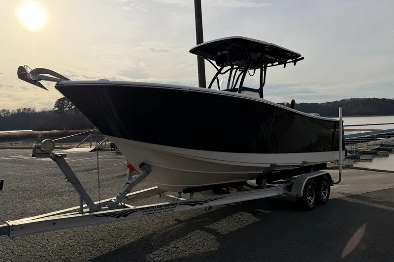 Slide: The Image of 2024 Sea Born SX239 Offshore boat on trailer at marina during sunset. - 5